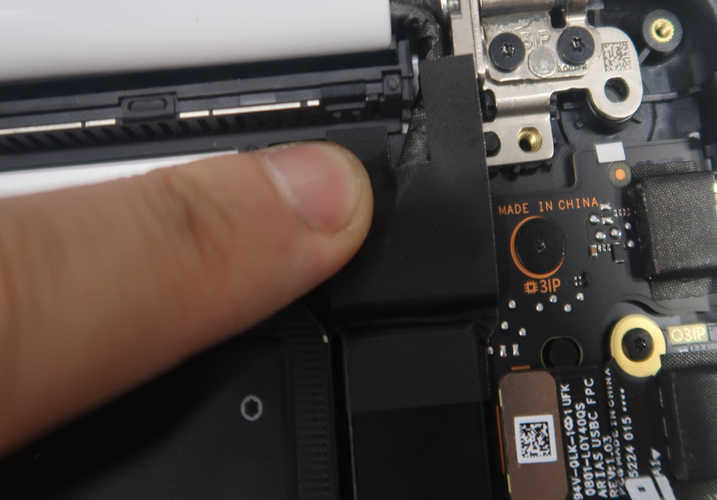 A finger on a black device.