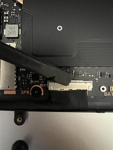 Screenshot that shows using a spudger to ensure the display connector buckle is closed.