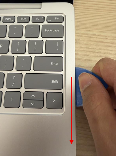 Photo of positioning the pick at 45 degrees to disengage the plastic snaps.
