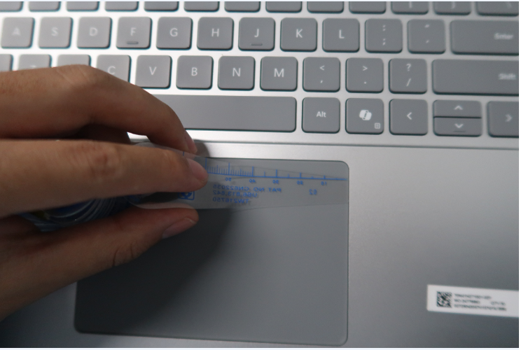 Screenshot that shows using a 0.2-mm feeler gauge around the trackpad perimeter to check alignment.
