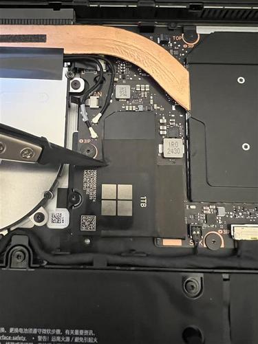 Screenshot of removing the conductive tape on SSD with tweezers.