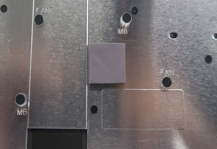 Screenshot that shows placing the top thermal pad onto the C Cover after removing the liner.