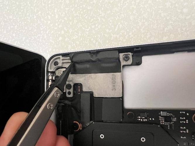 Screenshot that shows removing conductive tape from the USB-C connectors with tweezers.