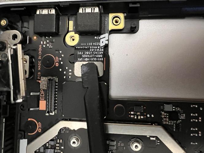 Screenshot of using a spudger to connect USB-C FPC to connector.