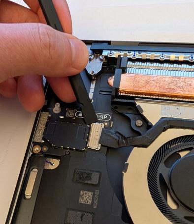 Screenshot that shows disconnecting the Micro SD reader cable using a spudger