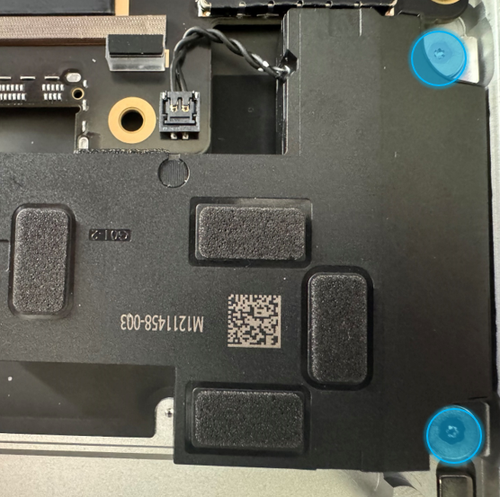 Screenshot that shows using a 3IP (Torx-Plus) driver to remove the two screws securing the left speaker.