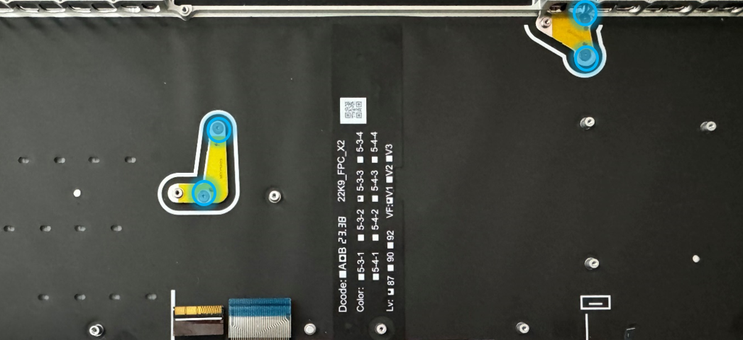 Screenshot that shows a black mounting bracket board with white text and blue and yellow tape.