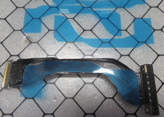 Screenshot that shows adhesive sheet aligned to back of Surface Connect port before liner removal