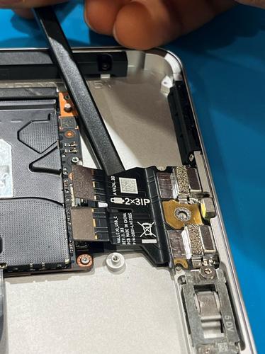 Photo that shows using a nylon spudger to separate the USB-C FPC from the enclosure.