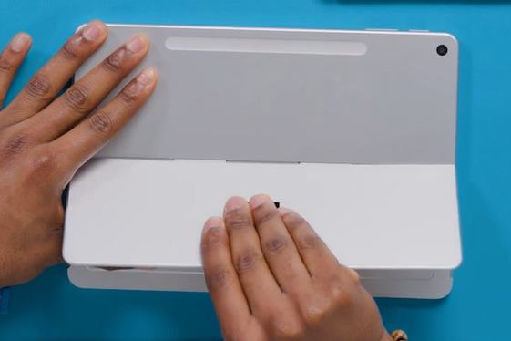 Screenshot that shows pulling the kickstand out of the enclosure so the foam inserts slide free.