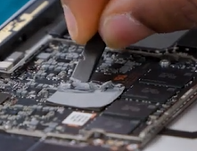 Screenshot that shows cleaning TIM residue from the motherboard with a nylon spudger.