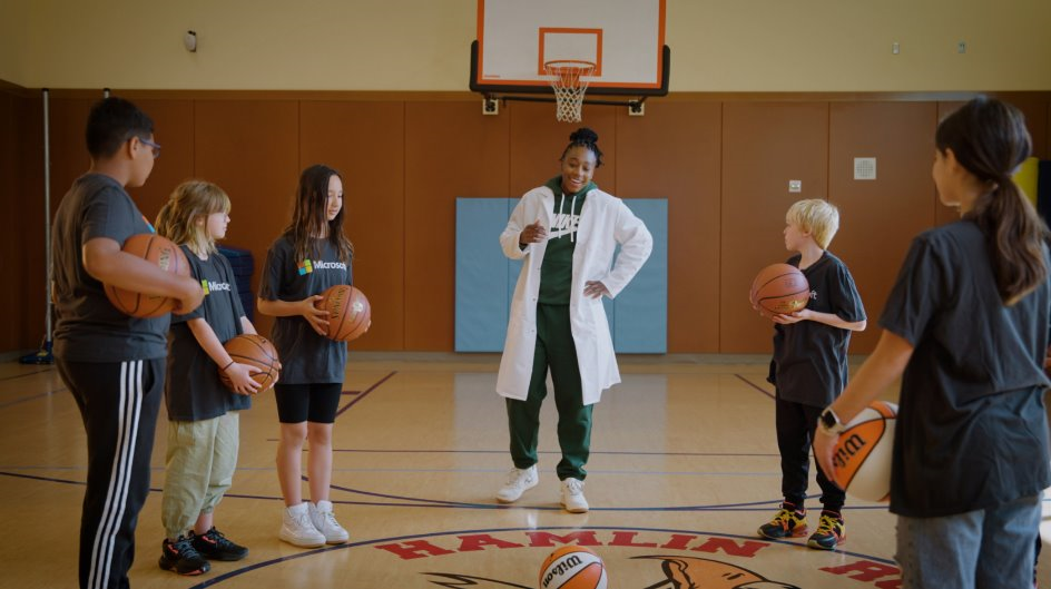 An image of a basketball coach with players.