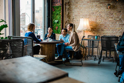 Screenshot of people talking around a table.
