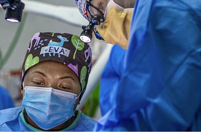 Screenshot of a two surgeons working.